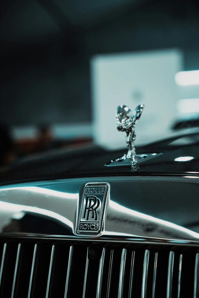 Detailed view of Rolls Royce grille and Spirit of Ecstasy ornament. Luxurious automotive photography.