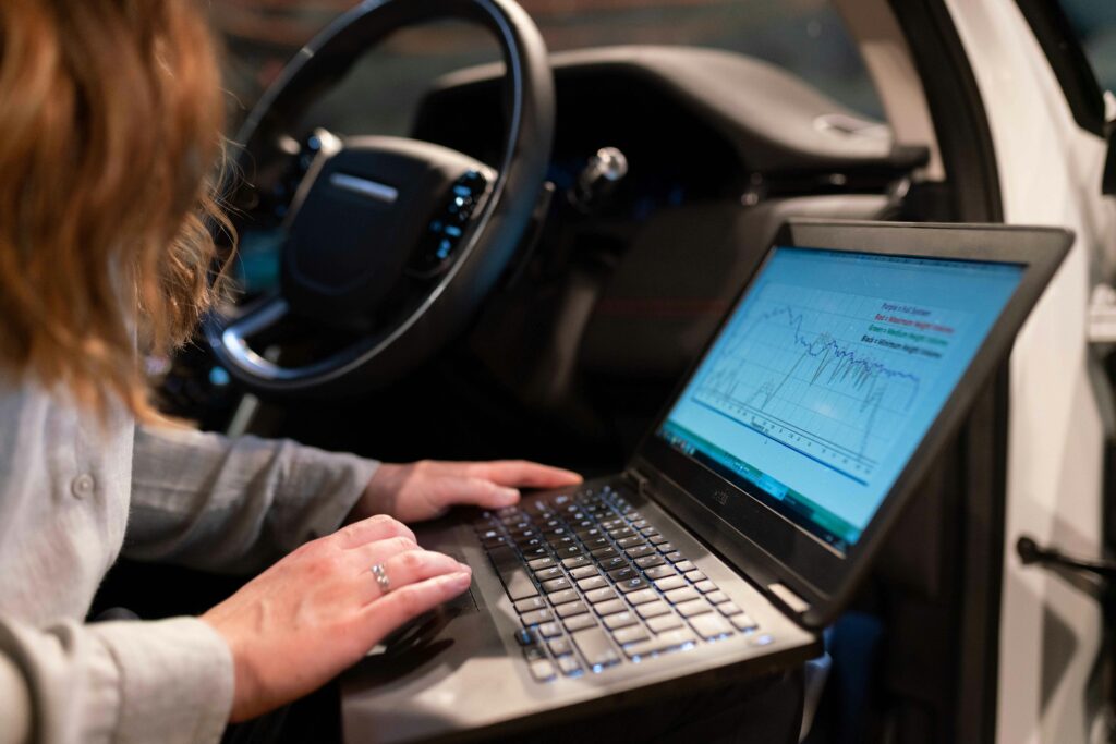 pexels photo 3862610 3862610 Female engineer using laptop to analyze vehicle data inside a car for testing purposes.