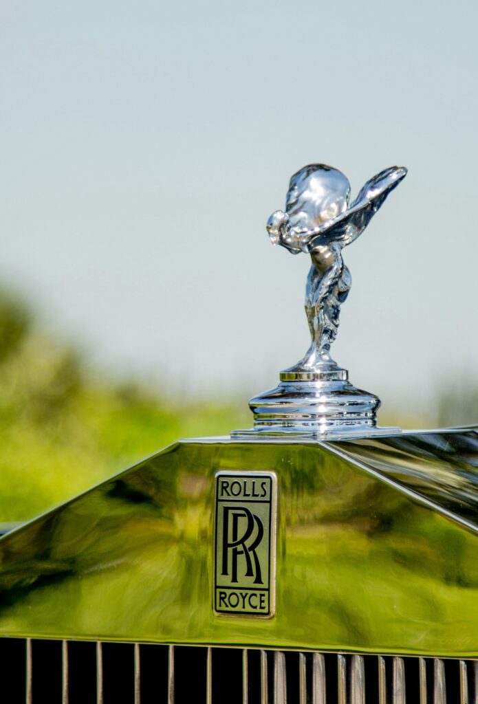 pexels photo 5804275 5804275 Detailed view of a Rolls Royce emblem and glossy hood ornament showcasing luxury and elegance.