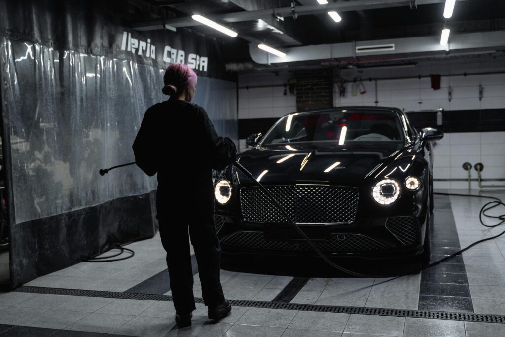pexels photo 6872577 6872577 A luxury car being washed inside a car service garage by a professional.